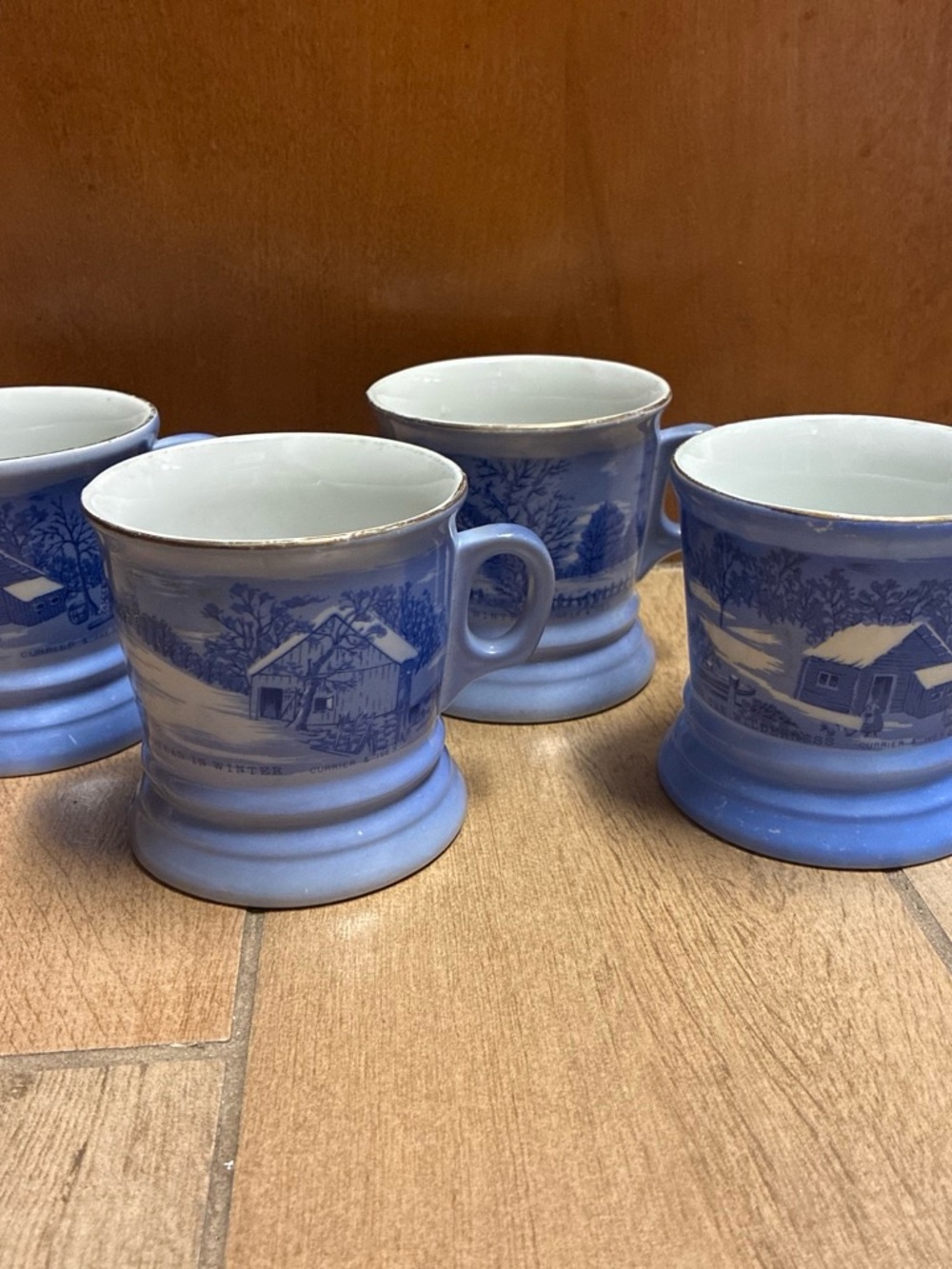 Set of 4 Currier & Ives Blue and white ceramic mugs with gold rim.